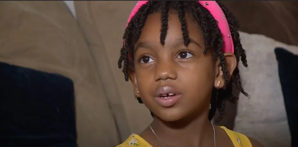 Paris in a pink headband talking during a FOX interview